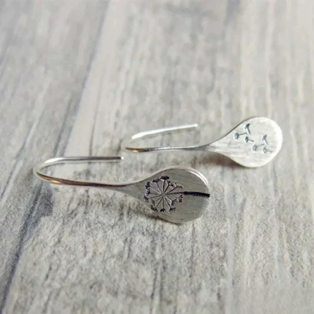Elegant silver earrings in a dandelion leaf design